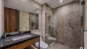 A modern bathroom with a marble shower, a sink with a mirror, and a toilet. - NOK Stylish 1BR Apartment in la Candelaria Bogota (Bogotá)