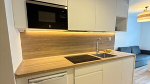 A modern kitchen with a built-in microwave, a sink, and a dishwasher. - Modern Studio in Candanchú, 4 ppl, 2 beds (Aisa-Candanchú)