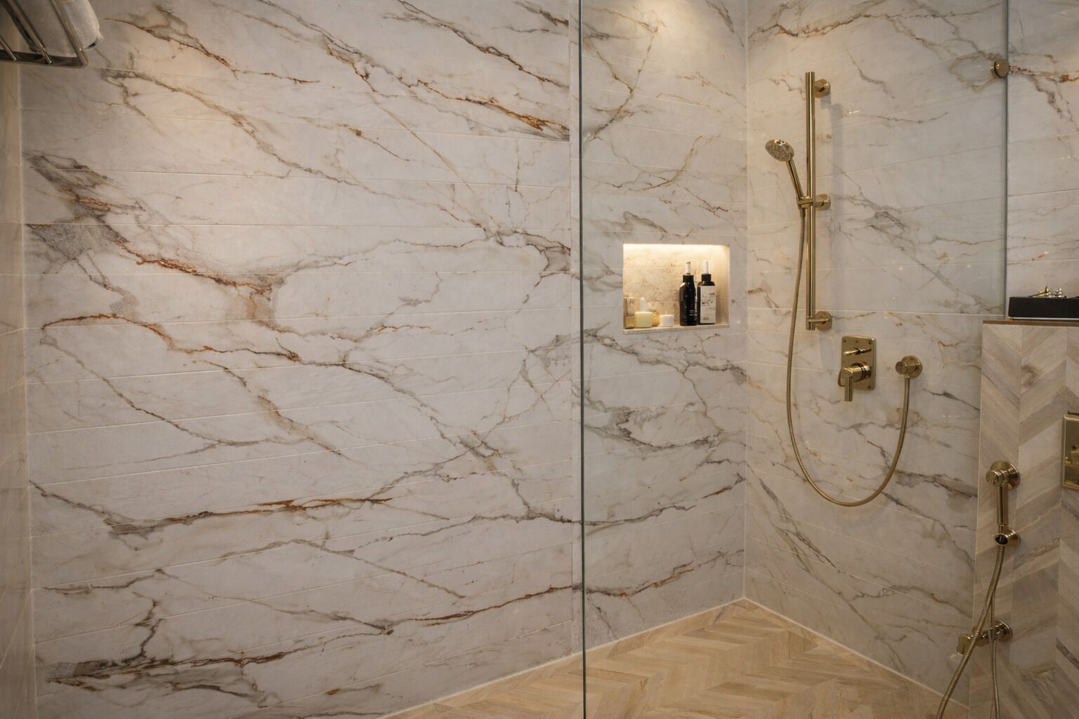 A modern bathroom with marble walls, a shower area, and a wooden floor.
