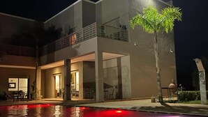 A modern two-story house with a swimming pool at night. - Dar Fatima Tamazouzt (Tamazouzte)