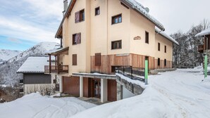 A multi-story building with a sloped roof, wooden balconies, and a sign indicating it is a ski resort. - Ski Retreat in Saint-sorlin-d'arves (Saint-Sorlin-d'Arves)