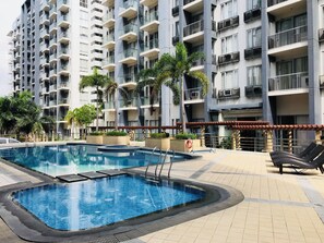 Outdoor pool, open 8:00 AM to 10:00 PM, pool umbrellas, pool loungers - One Palm Tree Villas Across MNL Airport T3 (Pasay)