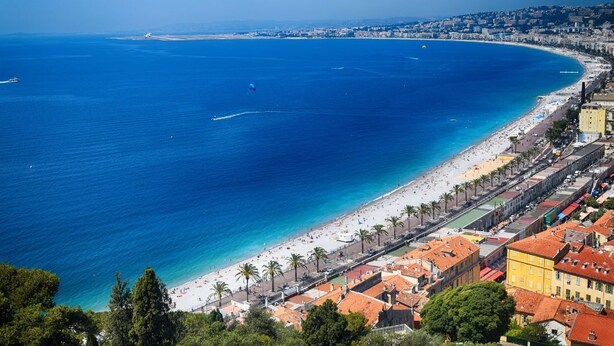 A coastal cityscape with a wide beach, clear blue sea, and a row of buildings along the shore. - SAINT-JEANNET, Village in the Préalpes d'Azur, near NICE, SAINT-PAUL-DE-VENCE (Saint-Jeannet)