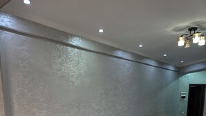 A hotel room with two wooden beds, a marble-patterned floor, and a ceiling with recessed lighting. - Sarvat Hotel (Dushanbe)