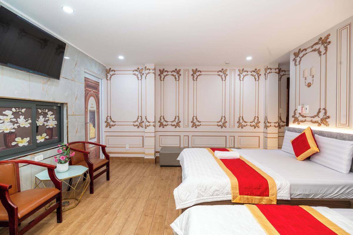 A hotel room with a bed, a desk, and a chair.