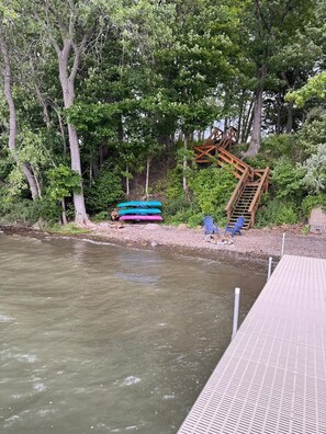 A dock with a wooden staircase leading to a platform, surrounded by trees and a calm river. - Private Beach with Views: Stonehouse Estate, Near Wine Trail and Spa (Aurora)