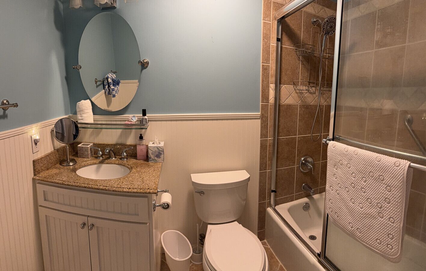 A bathroom with a sink, toilet, and shower.