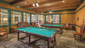 A pool hall with multiple pool tables, wooden walls, and green-tinted windows. - Spacious 2-Bedroom Williamsburg Escape, Just Moments from Busch Gardens (Williamsburg)