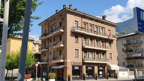 A multi-story building with a ground-floor restaurant and upper-floor apartments. - "Valeri" Vacation Rental in Sondrio - Peaceful Stay Near City Center (Sondrio)