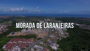 An aerial view of Morada de Laranjeiras, featuring a mix of residential buildings, roads, and green areas.