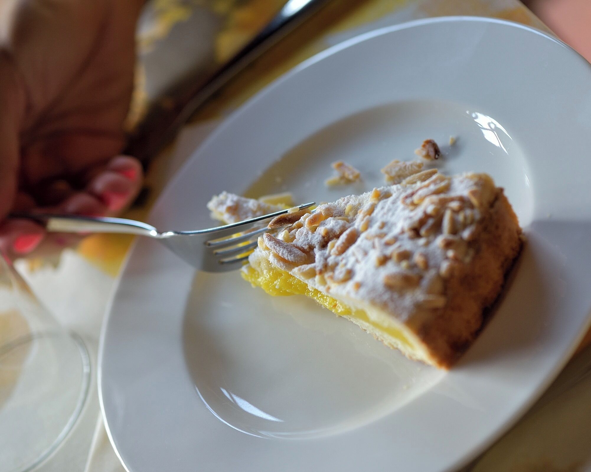 A slice of cake on a white plate with a fork.