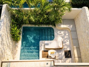 A rooftop pool with a hot tub, surrounded by lush greenery. - Root Bumbak Bali (Kerobokan)
