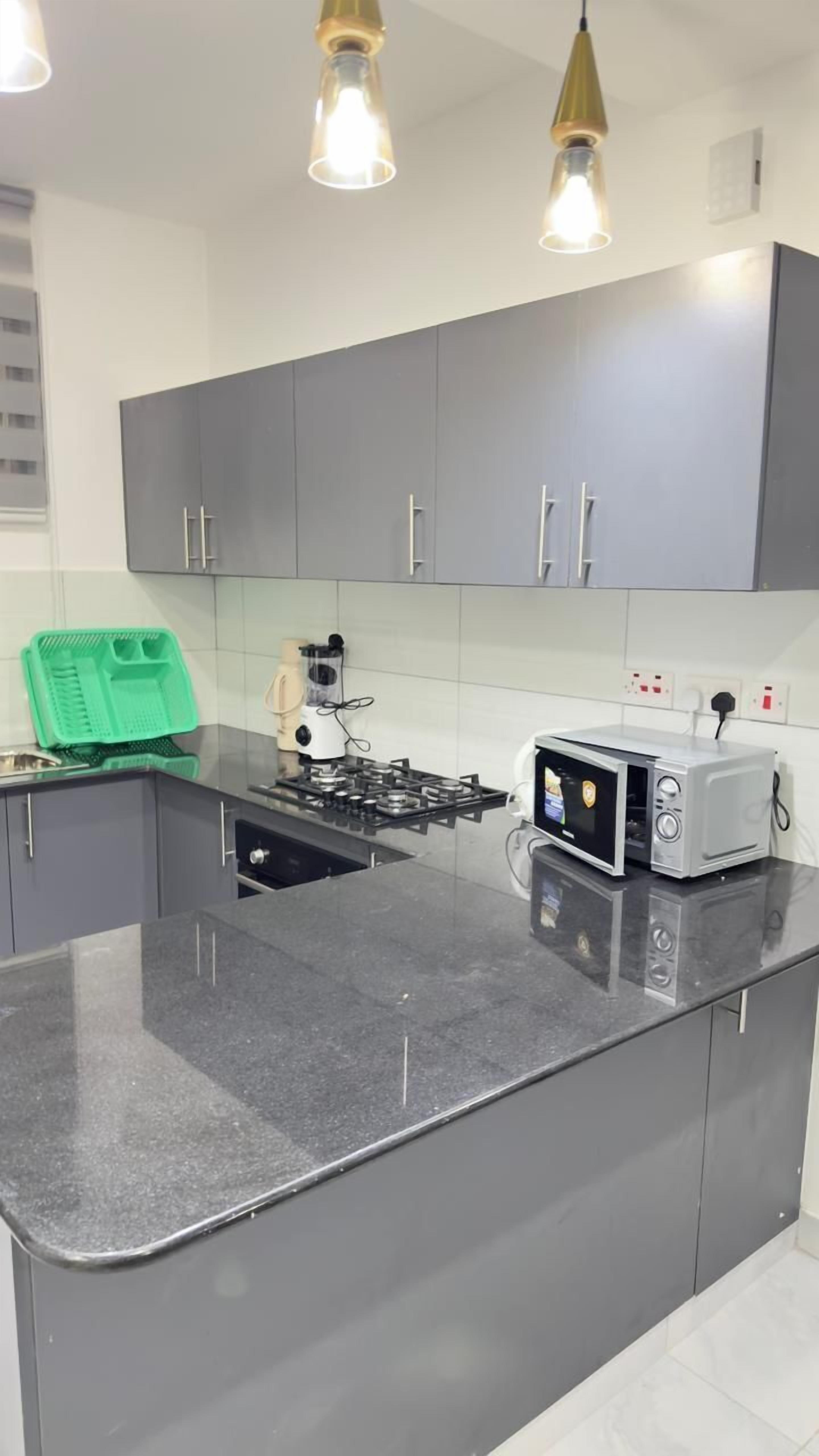 Een koelkast met diepvriezer, een microgolfoven, een oven, een kookplaat