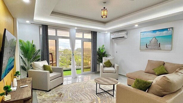 A modern living room with a sofa set, a coffee table, and a decorative rug.