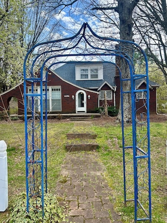 A house with a brick exterior, a front door, and a number '6606' on the wall.. Downtown Lewisville-Century Old Home-The New Orleans