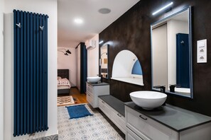 A modern bathroom with a large mirror, a white sink, and a dark wooden accent wall. - Luxury Family Home 3BR / 3BA 200m² Duplex | A/C | Walkable area | (Budapest)