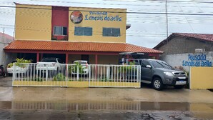 A building with a yellow facade and a red roof, labeled "Pousada Lencóis do Della." - Pousada Delta (São Luís)