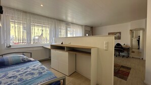 Ein Schlafzimmer mit einem Bett, einem Schreibtisch und einem Stuhl.
