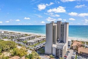 A coastal residential area with high-rise buildings, a beach, and a clear blue sky. - Updated Oceanfront Condo/Pools, Sauna, Hot Tub, Balcony View, Free Parking (Myrtle Beach)