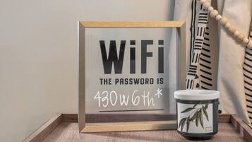 A framed sign with the text "WiFi: The password is 430w6th*".