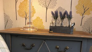 A dresser with a plaid cover, a clear lamp, and a sign that reads "IF YOU CAN DREAM IT YOU CAN DO IT!" - Central Chester home. Excellent location. Sleeps 4. Pet friendly. (Chester)