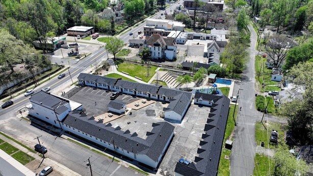 An aerial view of a large industrial building with multiple parking lots and a central courtyard. - The Bambino at PWC (Hot Springs)