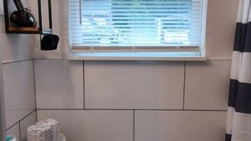 Un bagno piccolo con servizi igienici, lavandino e finestra.