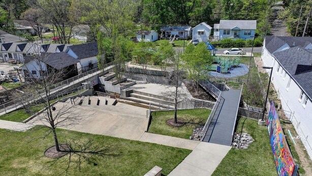 A residential area with houses, a playground, and a mural on a building. - The Gettysburg at PWC (Hot Springs)