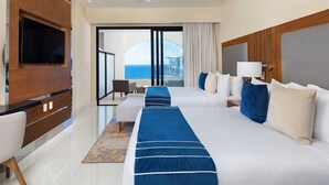 A hotel room with two beds, a TV, a ceiling fan, and a view of the ocean. - Stay at the 5-Diamond Villa la Valencia (San Jose del Cabo)