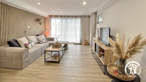 Ein modernes Wohnzimmer mit Sofa, Couchtisch und TV-Schrank.