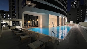 A rooftop pool area with lounge chairs and a glass-enclosed spa room. - Luxury Condo 2BR/2BA Downtown Miami 905 (Miami)