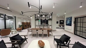 A modern interior with a dining area, seating, and a kitchen. - Luxury Condo 2BR/2BA Downtown Miami 905 (Miami)