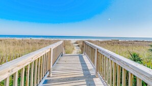 A wooden boardwalk leading to a beach with a clear sky. - Ocean Forest Plaza 2108 (Myrtle Beach)