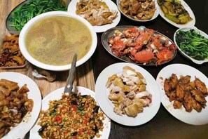 A variety of dishes arranged on a table, including seafood, vegetables, and a large bowl of soup. - Beihai Weizhou Xiaodeng Yujiale (Beihai)
