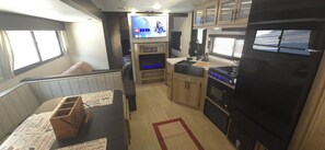Living area - New River RV Travel Trailer with 1 King bedroom and bunks - 2 small children. (Prince)