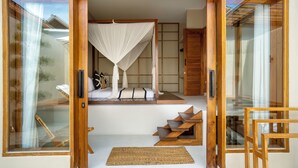 A room with a bed, a wooden ladder, and a woven mat. - YŪN Uluwatu (Pecatu)