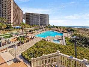 A resort with multiple swimming pools, a beachfront view, and high-rise buildings in the background. - Oceanfront Resort Condo with Pools (Myrtle Beach)