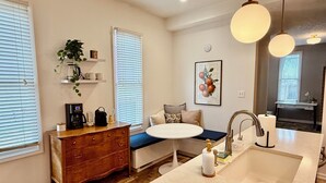 A bathroom with a sink, vanity, and a shower area. - Hot tub - Mass Ave - Sleeps 9 - Free parking (Indianapolis)