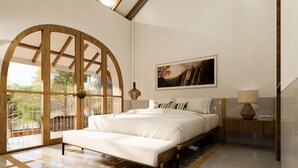 A bedroom with a large arched window, a bed with white bedding, a bedside table with a lamp, and a framed picture on the wall. - Villa Meru (Seminyak)