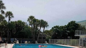 A rectangular swimming pool with clear blue water, surrounded by a tiled deck. - Venice Villas Upper Floor - Beachside (Venice)