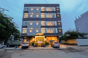 A multi-story hotel with a modern facade, multiple windows, and a sign indicating it is a Yashobhoomi Stay. - Yashobhoomi Stay (New Delhi)