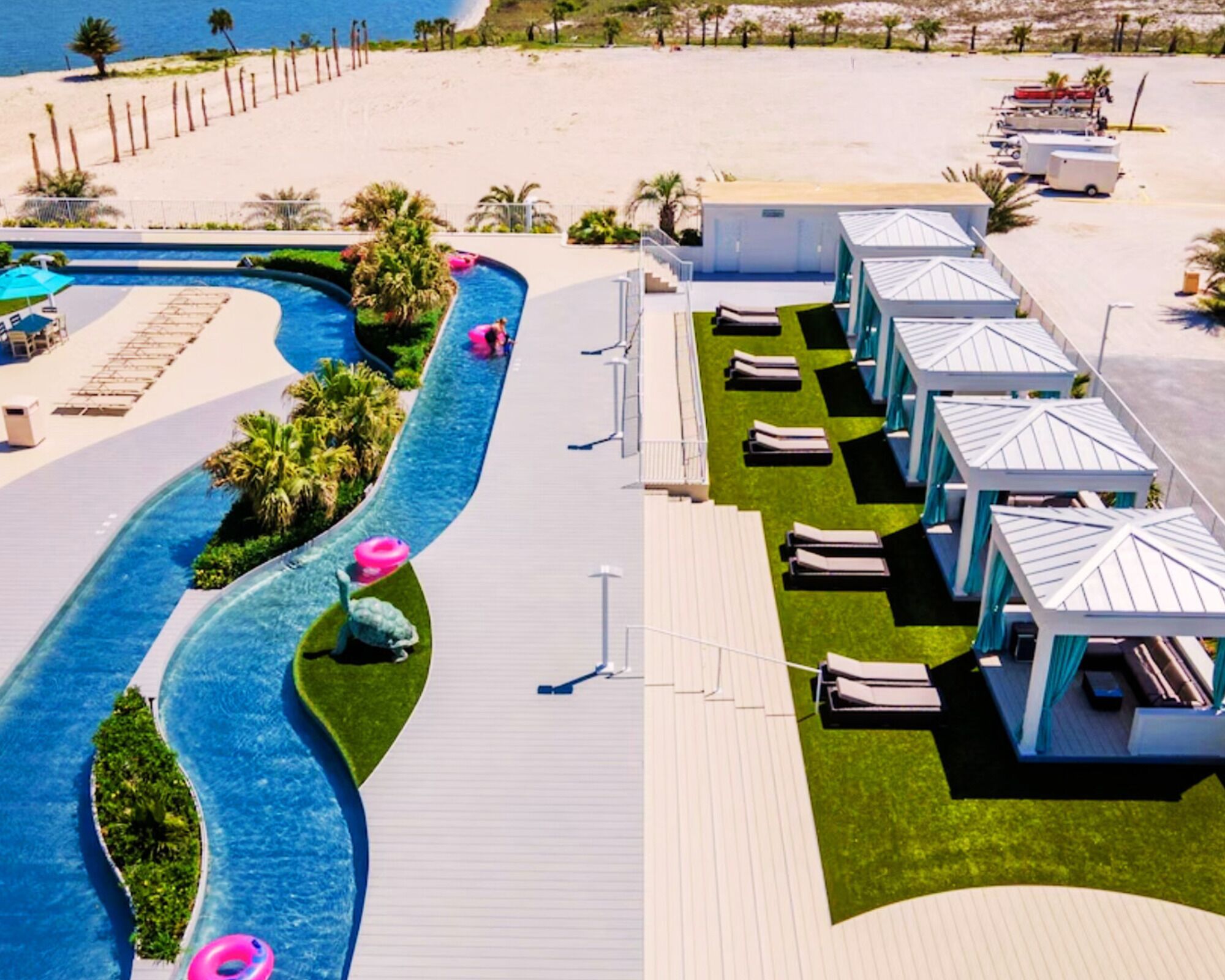 A resort with a pool, lounge areas, and beach access.