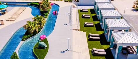 A resort with a pool, lounge areas, and beach access.