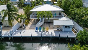 A beachfront property with a dock, multiple buildings, and a pool. - Kraken's Cove: 4‑bedroom Ramrod Key escape, minutes from open water (Summerland Key)