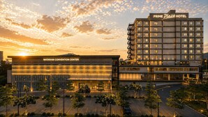 A hotel and convention center with a modern design, multiple floors, and a parking area. - Prime Plaza Hotel Mataram (Mataram)