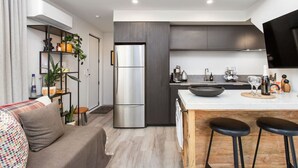 A modern kitchen with a central island, stainless steel appliances, and a minimalist design. - Boutique Sophisticated One Bedroom Hideaway (Christchurch)