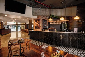 A restaurant with a bar area, wooden tables, and a patterned floor. - Brisbane City CBD Apartment w/ Pool, Gym & Parking (Brisbane City)