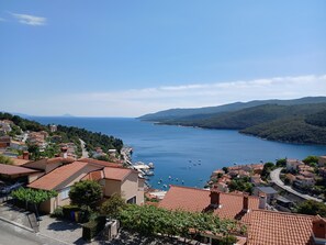 A coastal town with terracotta-roofed buildings, a marina, and a view of the sea and hills. - Apartment with fantastic views within walking distance of the beach and center (Rabac)