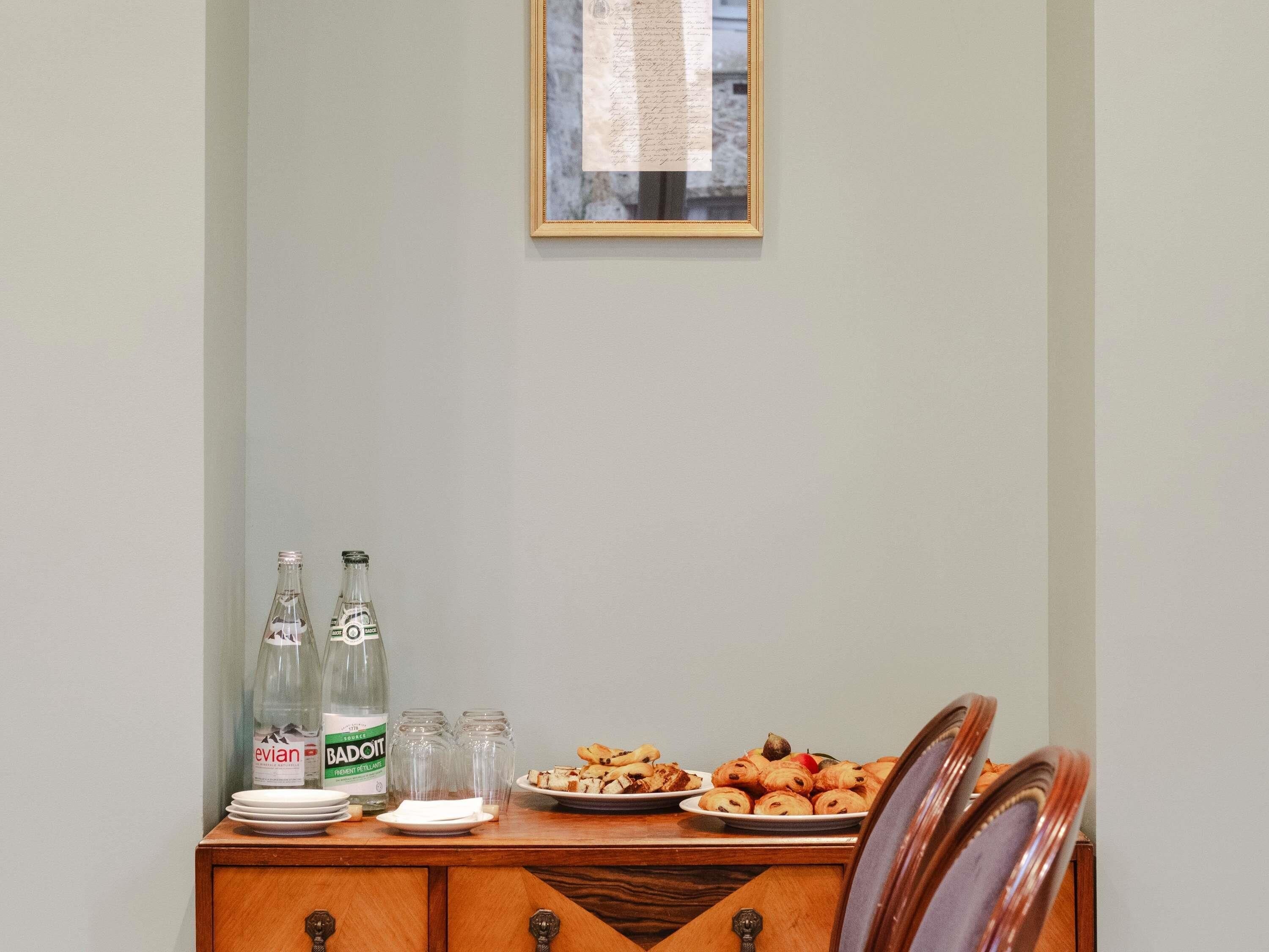 Een eettafel met borden eten, twee waterflessen en zout- en peperstel.