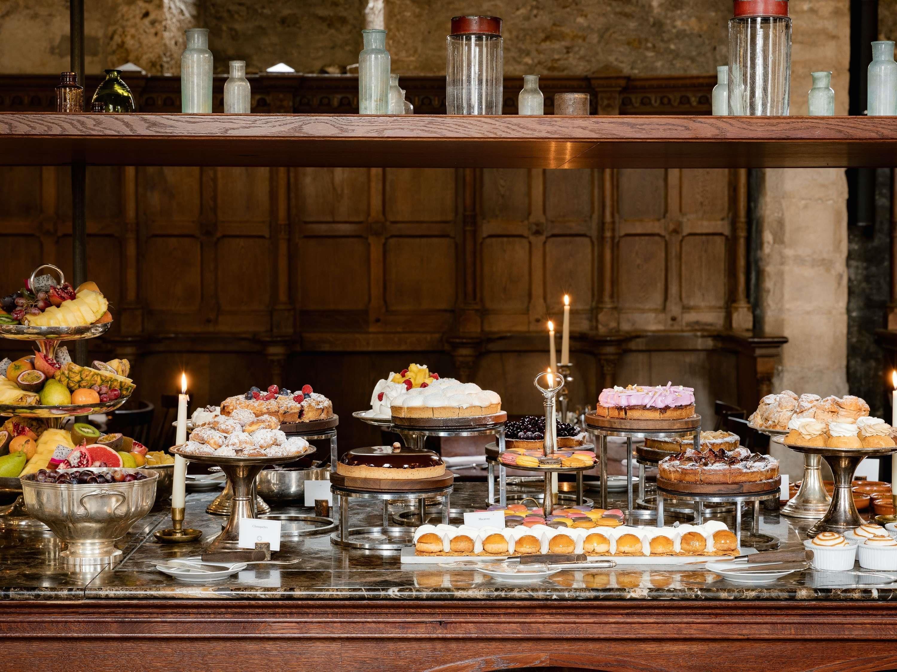 A buffet with various desserts and fruits.